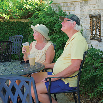 An older couple sitting next to a stone wall. Link to Life Stage Gift Planner Over Age 70 Situations.